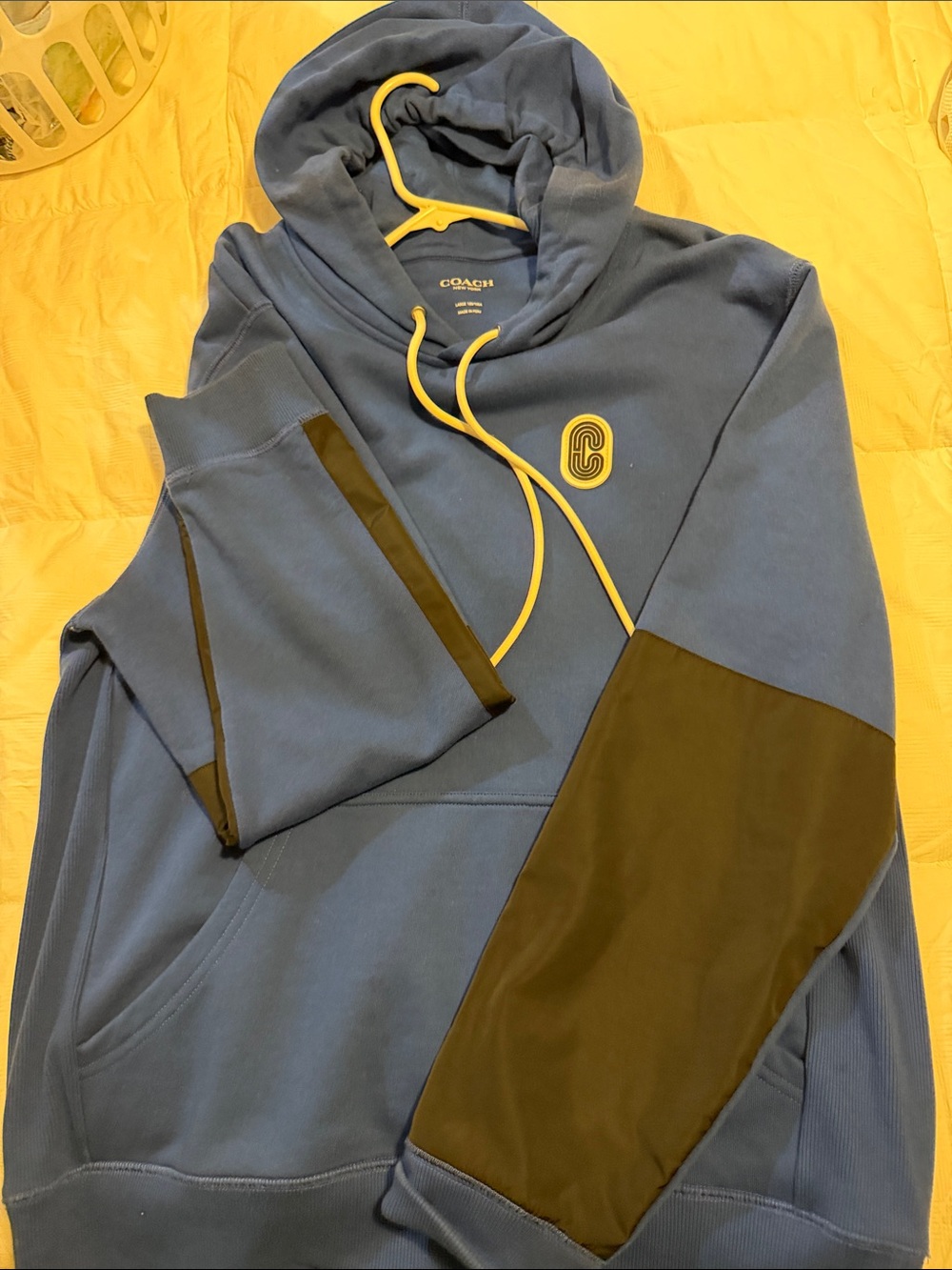 Coach blue hoodie with yellow accents and black panels